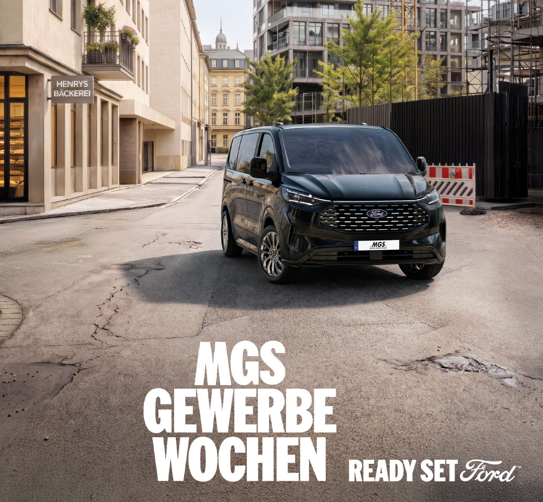 MGS Gewerbewochen mit einem schwarzen Ford Tourneo Custom auf einer Straße in städtischer Umgebung sowie dem Schriftzug „Ready Set Ford“.